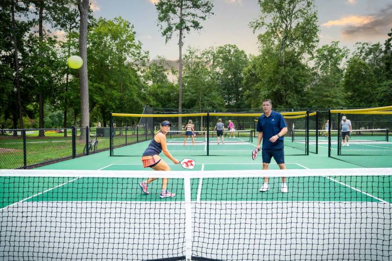 Doubles playing at the pickleball courts in Williamsburg Virginia. State of the art courts at Governor's Land.