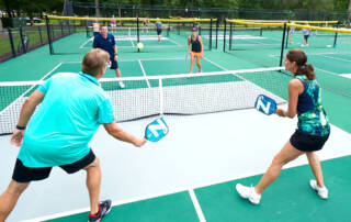 Couples playing pickleball at the courts at Governor's Land in Williamsburg, Virginia.