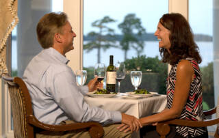 Man and woman relaxing into retirement by having a nice meal at a restaurant in Williamsburg, Virginia at Governors' Land.